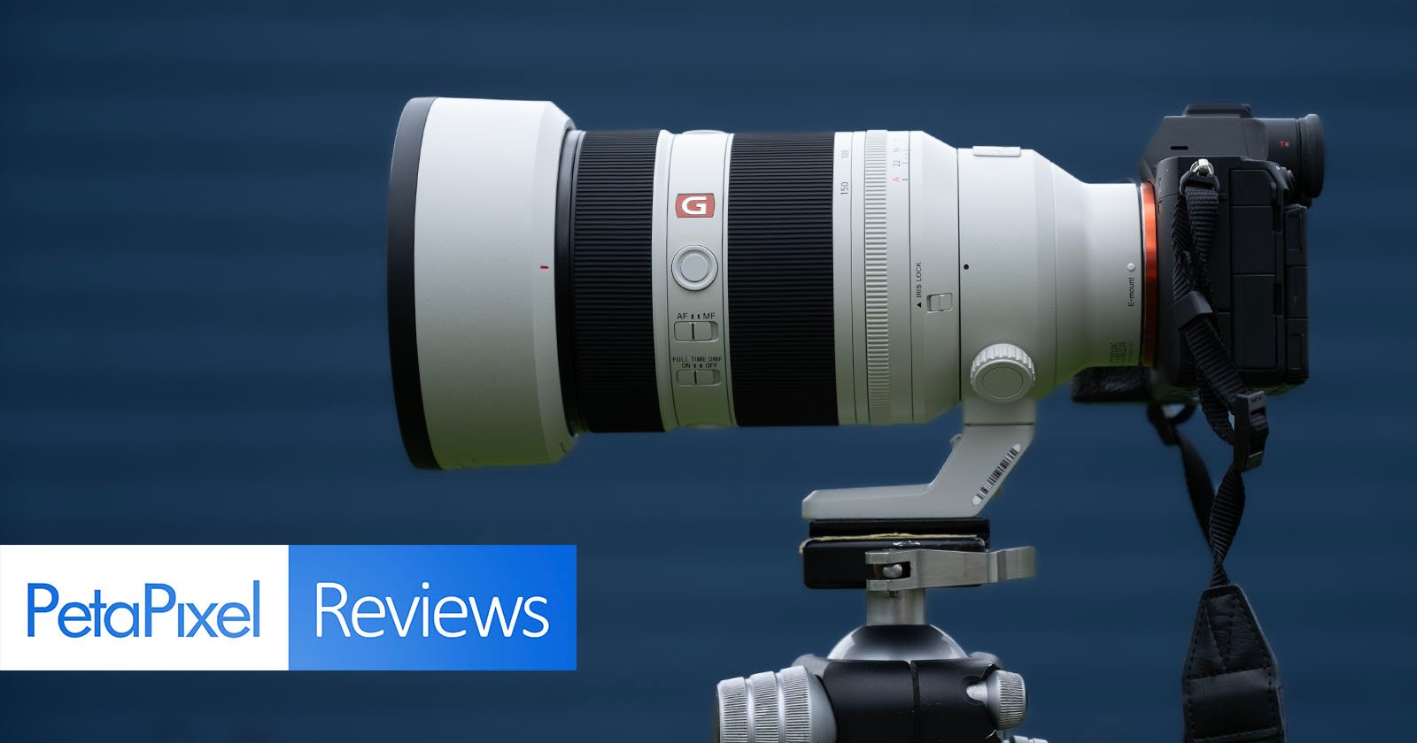A large white Sony G Master telephoto camera lens mounted on a tripod, attached to a camera body, with a blue background and PetaPixel Reviews text overlay.