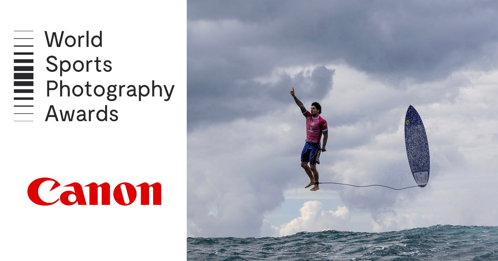 A surfer wearing a pink shirt appears to be mid-air above the ocean, with his surfboard flying nearby. The sky is cloudy. The left side features the text World Sports Photography Awards and the Canon logo.