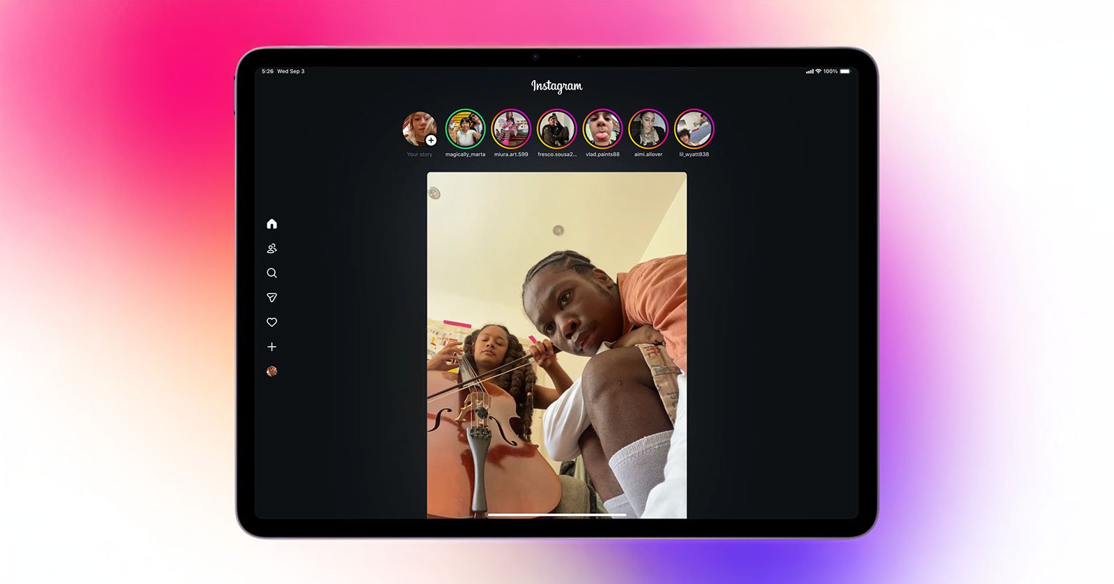 An iPad displays the Instagram app in dark mode, showing a vertical video of two people, one playing a cello and the other looking at the camera. Instagram stories icons are visible at the top.
