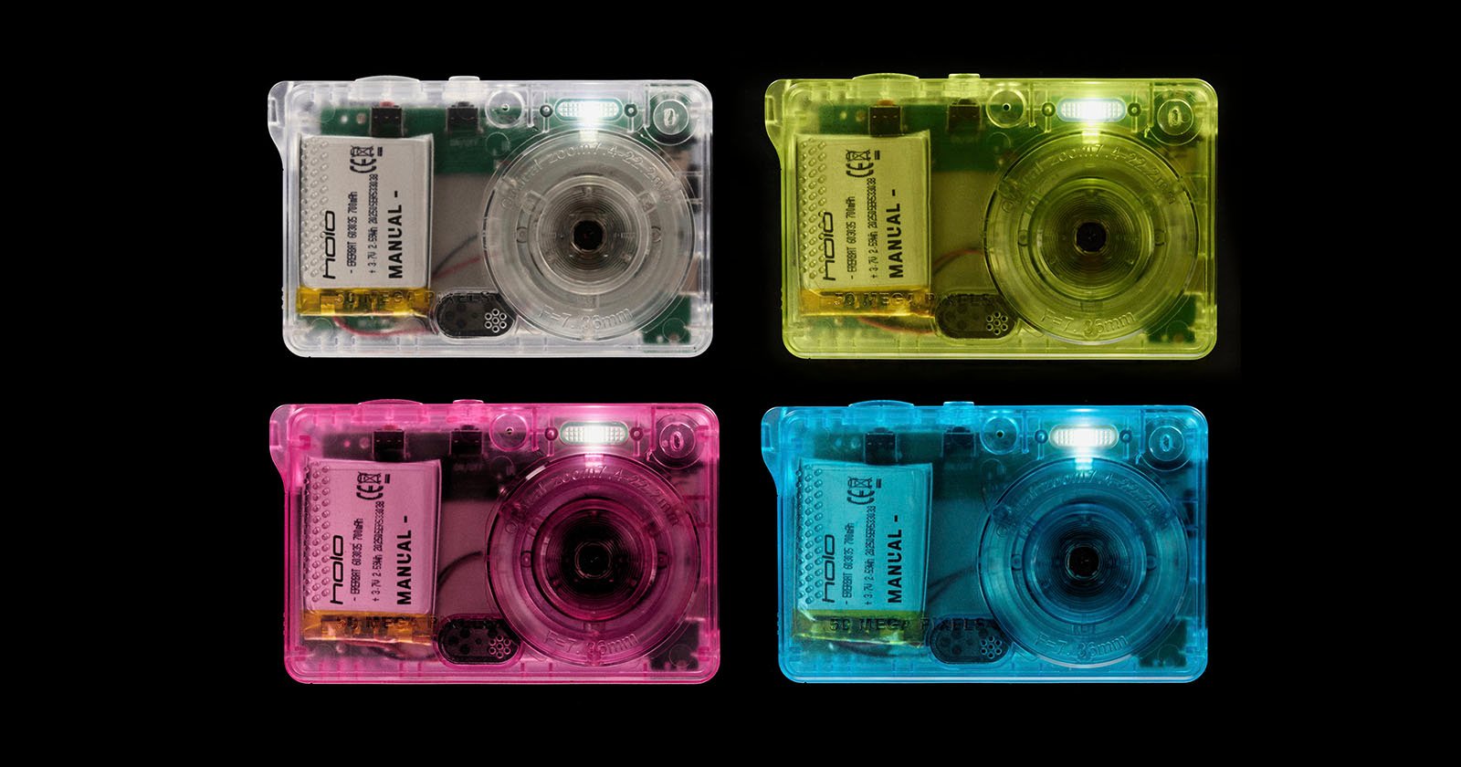 Four translucent plastic cameras in white, yellow, pink, and blue are arranged in a 2x2 grid against a black background, showing their internal components.