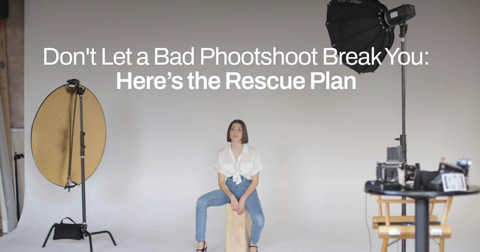 A woman sits on a wooden stool in a photography studio with white walls. She is surrounded by professional lighting and camera equipment. The text above her reads, Don't Let a Bad Photoshoot Break You: Here’s the Rescue Plan.