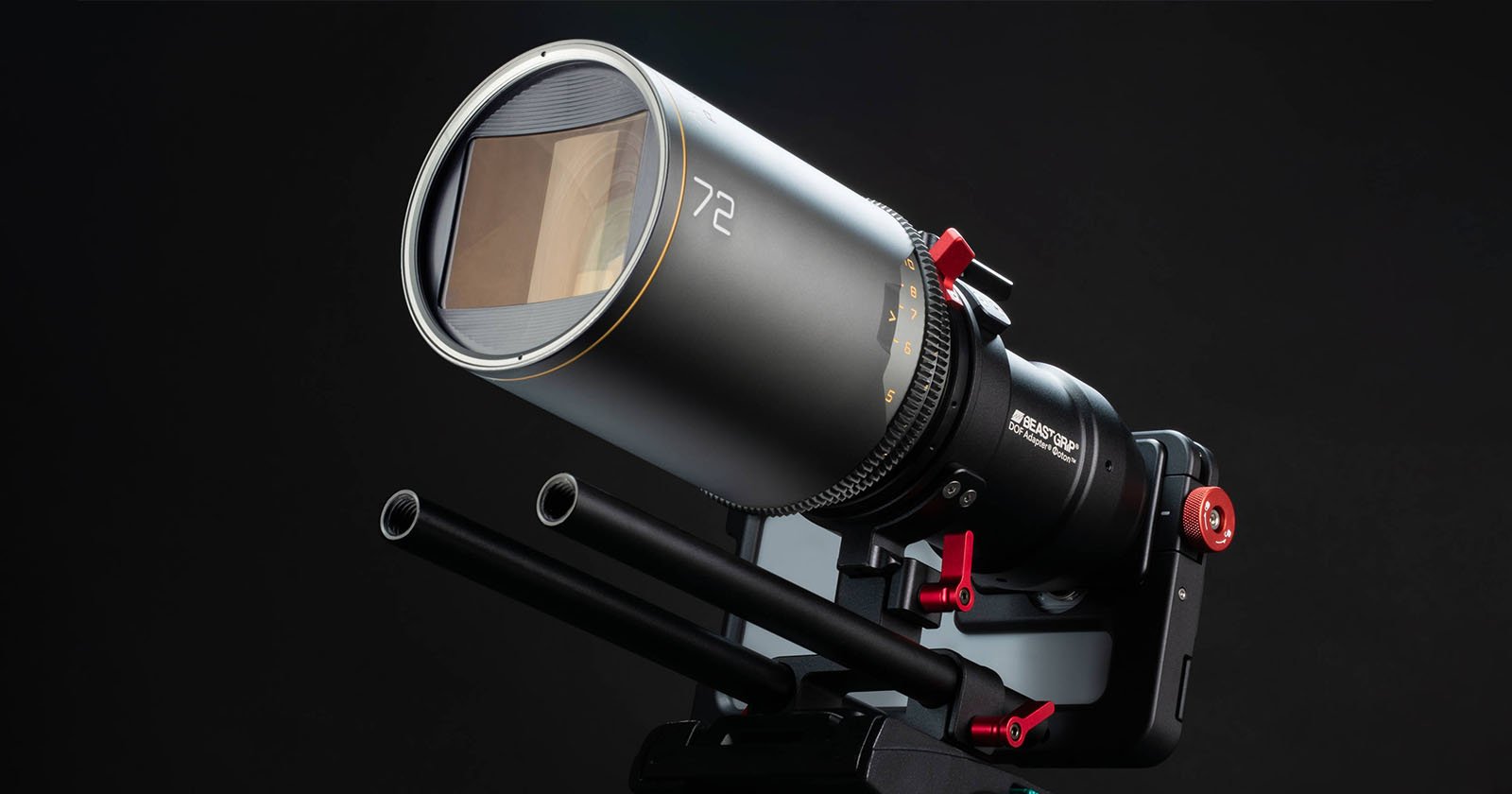 A professional camera lens mounted on a matte box with two rods for stabilization. The lens has a prominent 72 marking and features various dials and red accents for adjustments, set against a dark background.