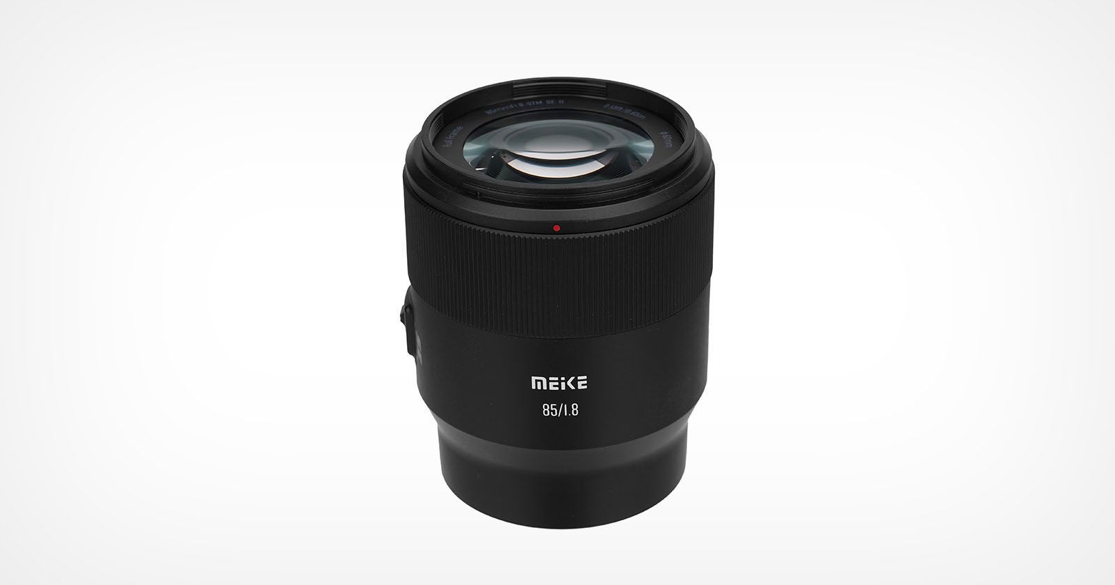 A black Meike 85mm f/1.8 camera lens is shown upright on a plain white background, with the brand name and lens specifications visible on the front of the barrel.