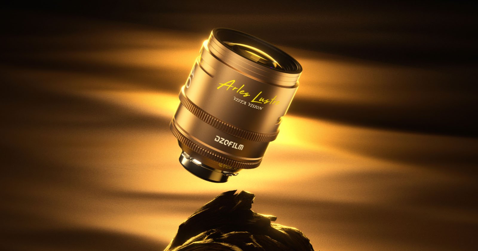 A golden camera lens with Arles Lumière and DZOFILM branding floats above a rock, illuminated by warm golden light against a dark, softly glowing background.