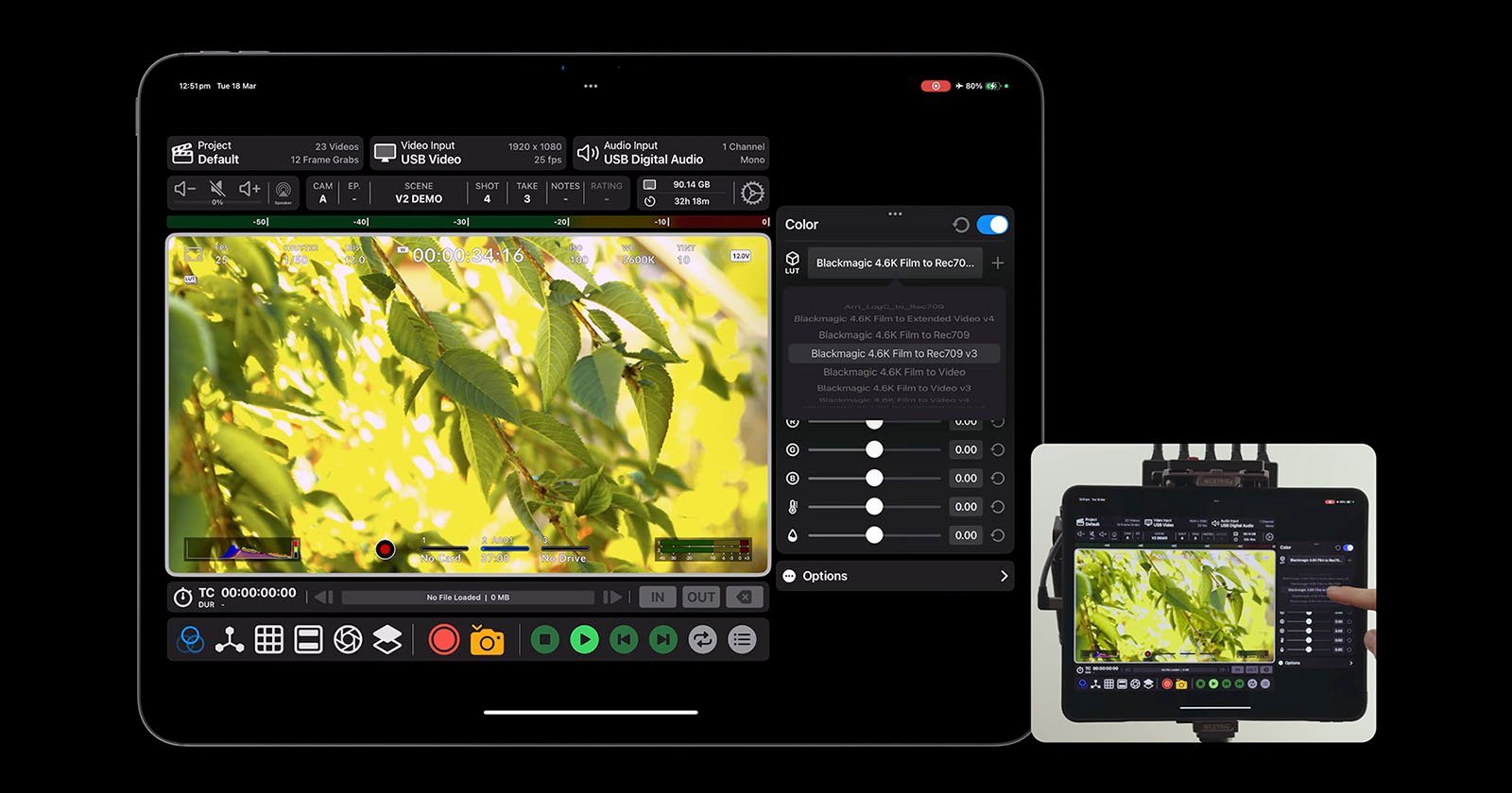A tablet displaying video editing software with a video of green leaves on a branch. The interface shows various controls and color adjustment tools. A smaller screen in the corner mirrors the main display.