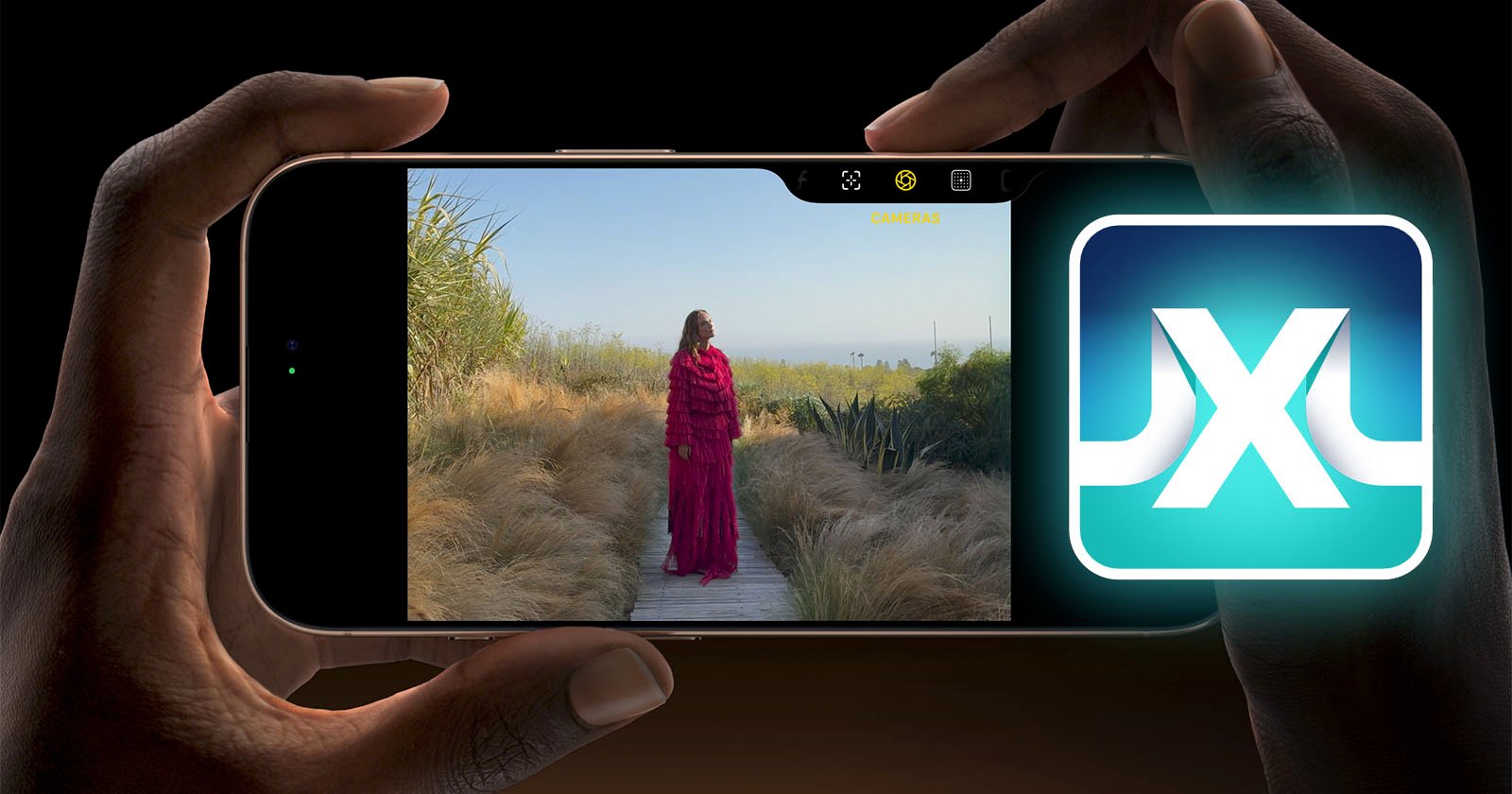 A person holds a smartphone horizontally with an image of a person in a red dress standing on a wooden path in a grassy outdoor area displayed on the screen. There is also a glowing icon featuring an X on the right side of the image.