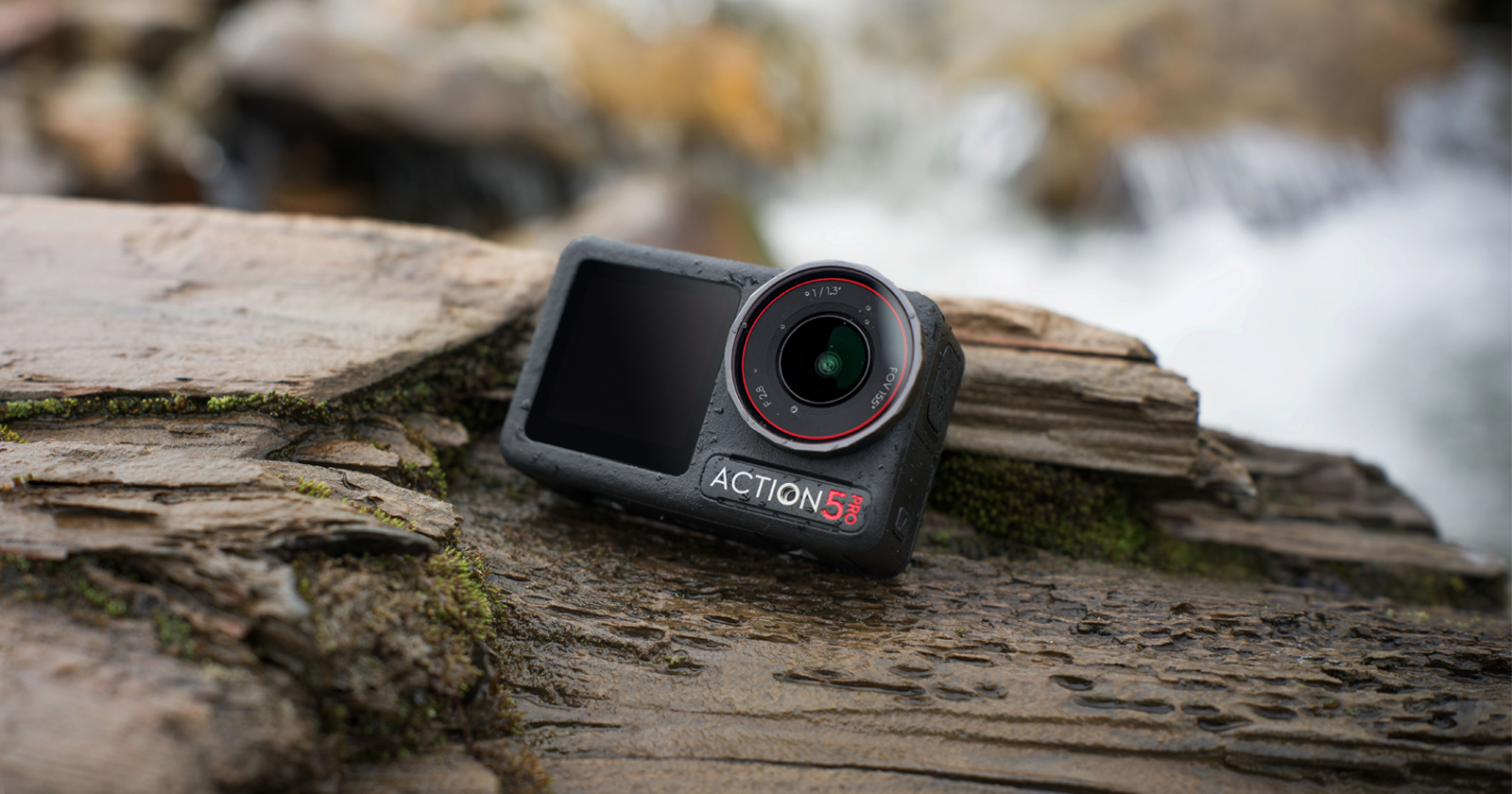 A rugged action camera with ACTION 5S branding is placed on wet, textured wooden surfaces near a flowing stream. The scene conveys a sense of adventure and durability in outdoor settings.