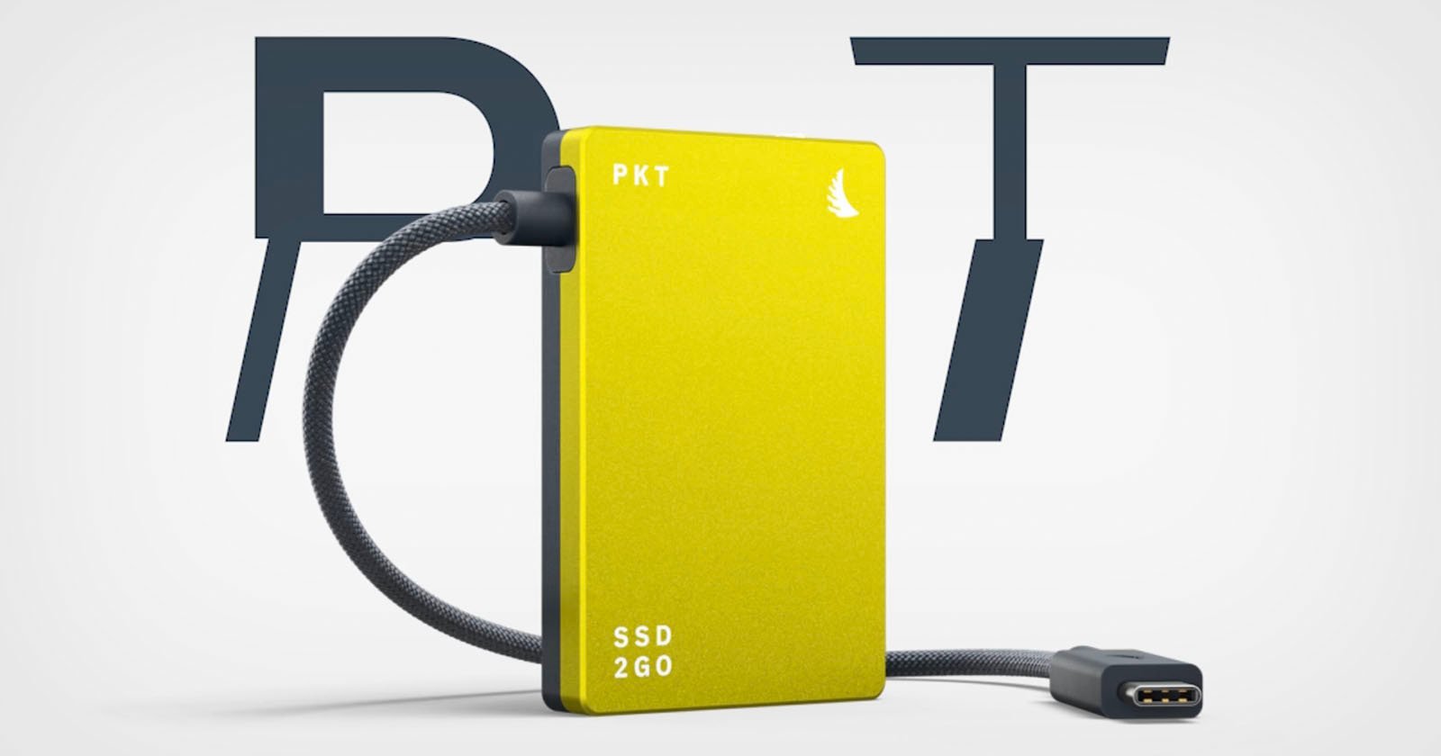 A yellow PKT SSD 2GO with a braided USB cable is displayed in front of large overlapping letters P and T on a white background.
