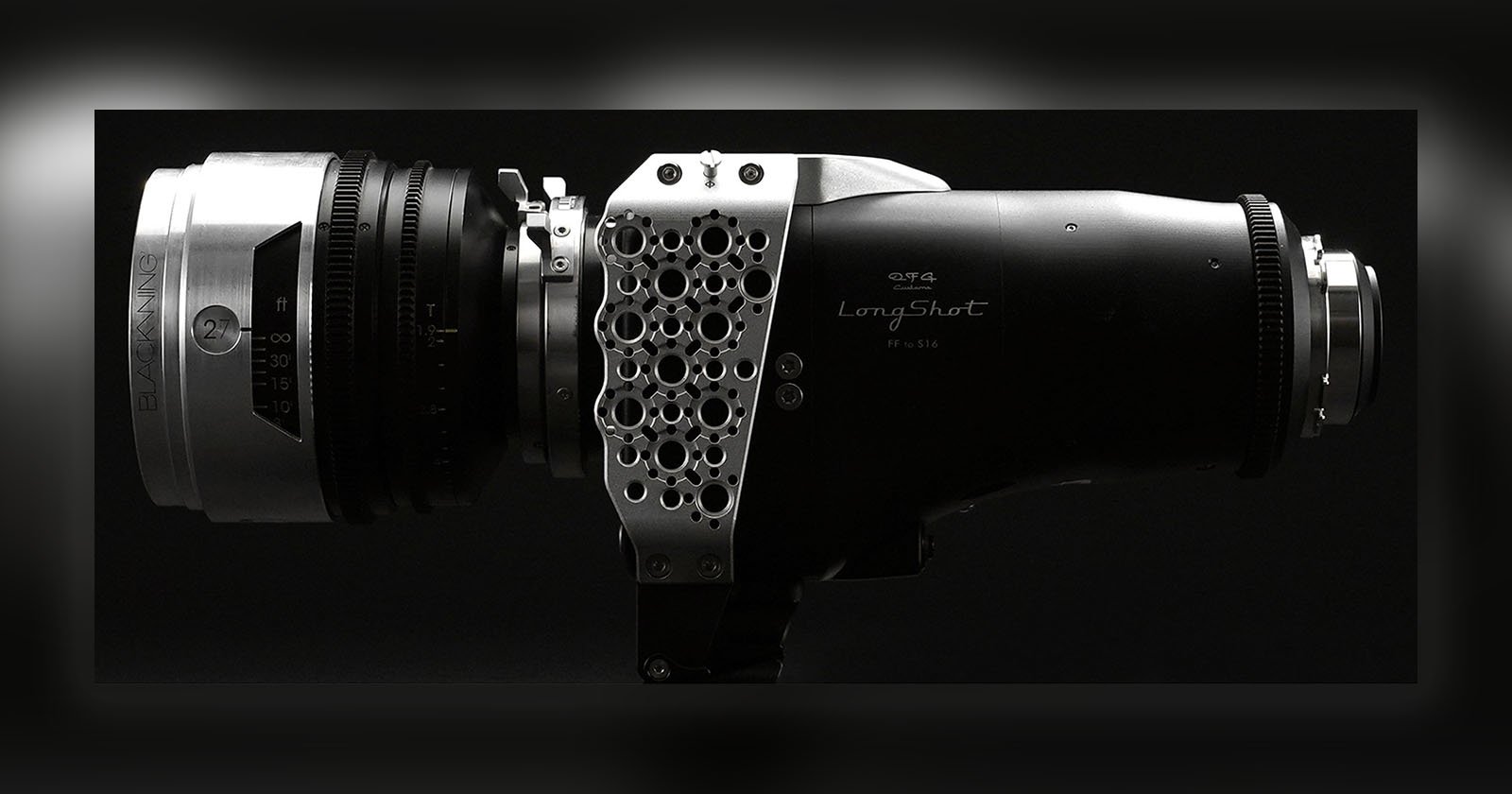 A close-up side view of a high-end, black and metallic LongShot camera lens with a honeycomb-patterned metal side panel, set against a dark background.