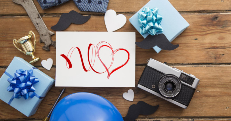 A camera with wrapped presents on a wooden table