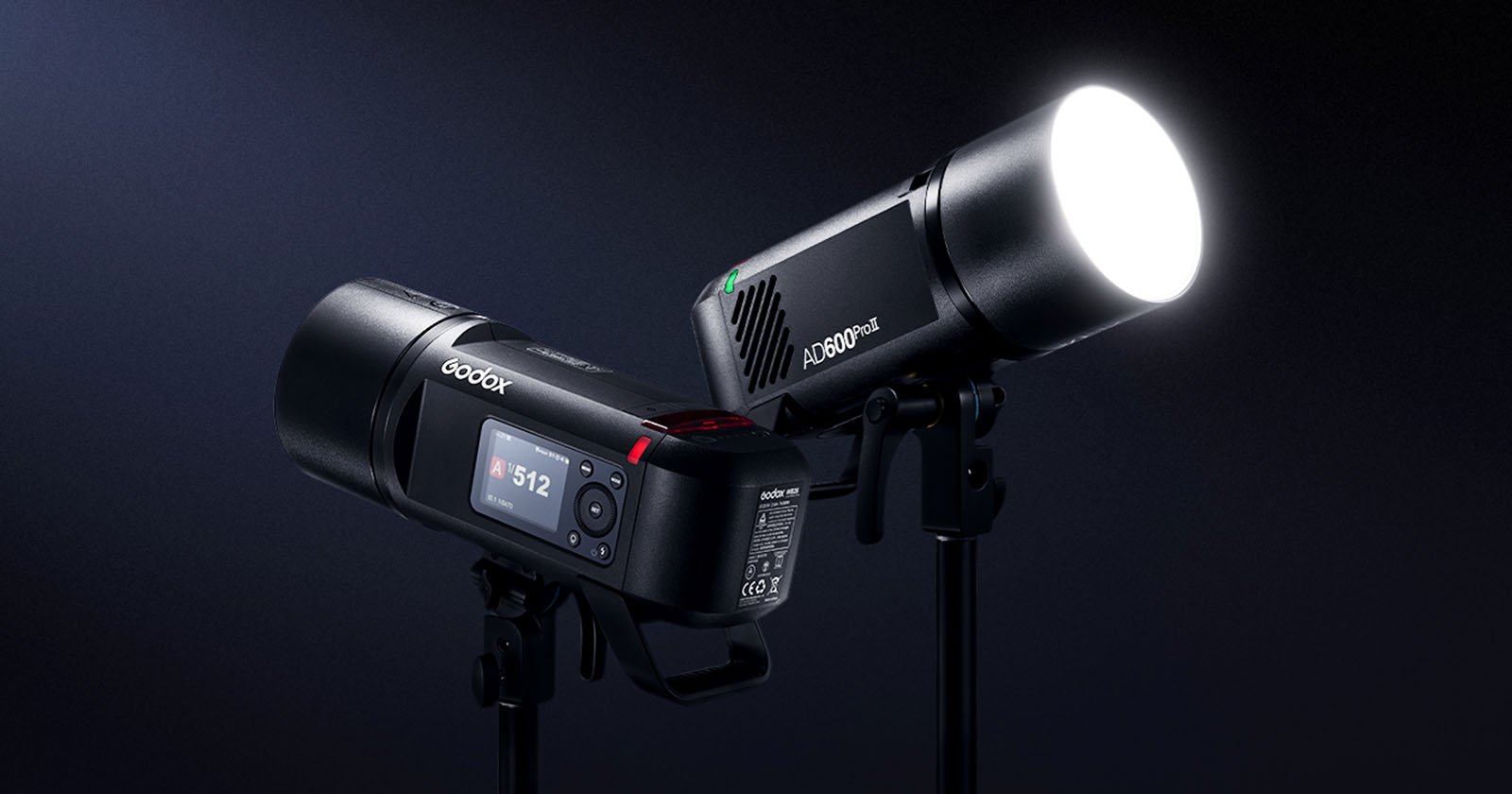 Two professional studio lights are displayed against a dark background. The light on the right emits a bright white light, while the light on the left features a visible control panel with a display reading 312. Both lights are mounted on stands.