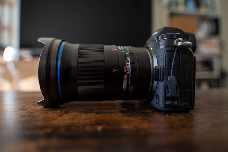 The Laowa Argus 45mm f/0.95 FF mounted on a camera and sitting on a table