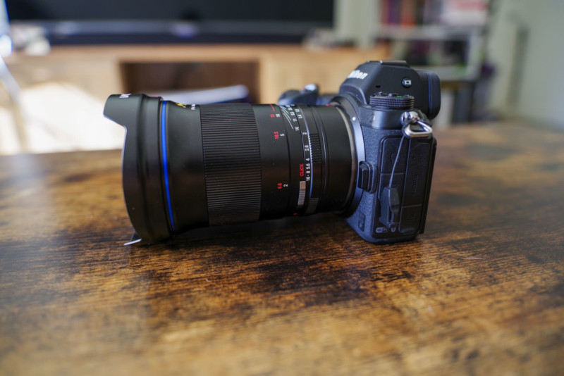 The Laowa Argus 45mm f/0.95 FF mounted on a camera and sitting on a table