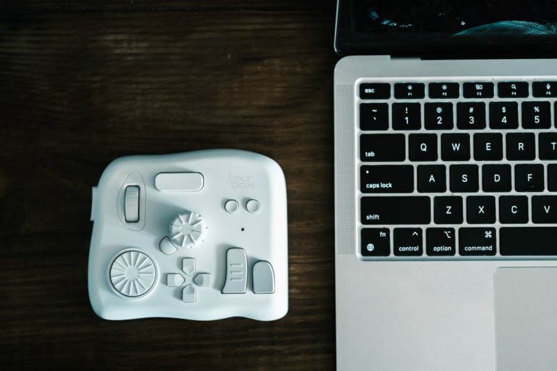 TourBox Elite in white next to MacBook Air