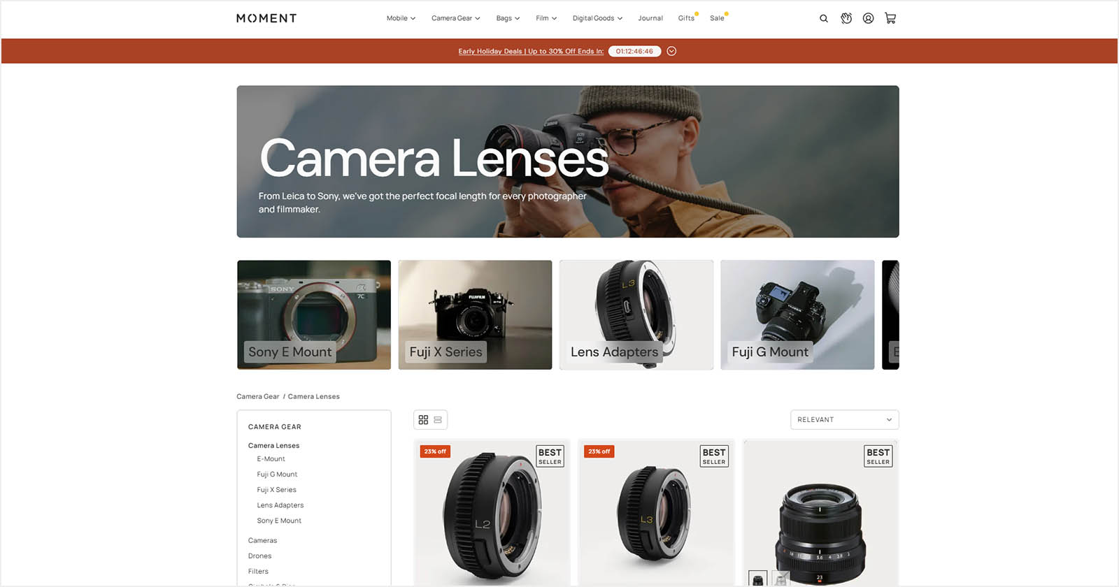 Screenshot of a webpage from Moment featuring camera lenses and accessories. A banner shows a photographer using a camera. Below, there are lens categories like Sony E Mount and Fuji X Series, with images of specific lens products displayed for sale.