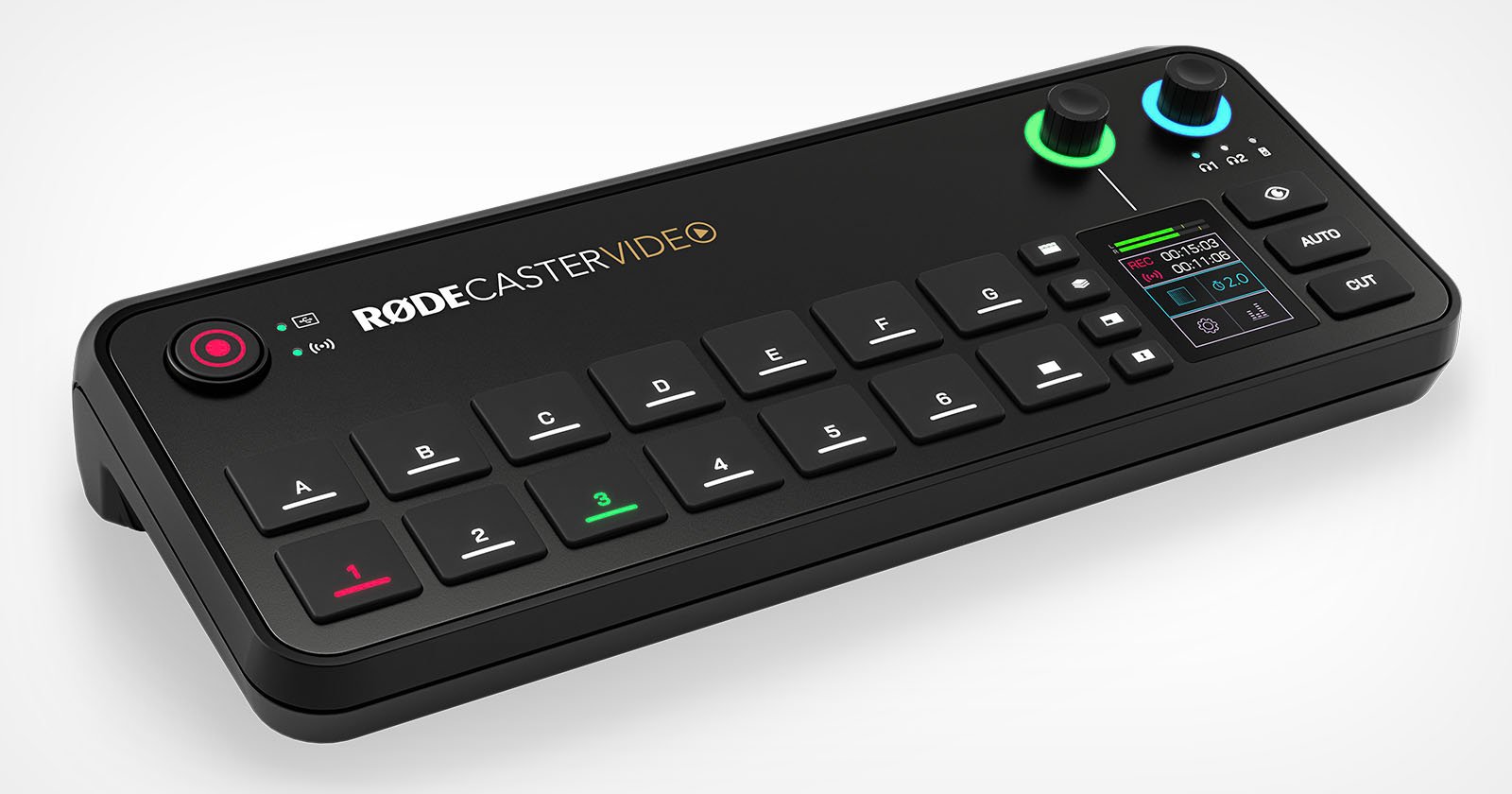 An electronic audio mixer device with the label RODECaster Video is shown. It features multiple black buttons, two knobs (one green and one blue), and a small digital display with various colored indicators and settings.