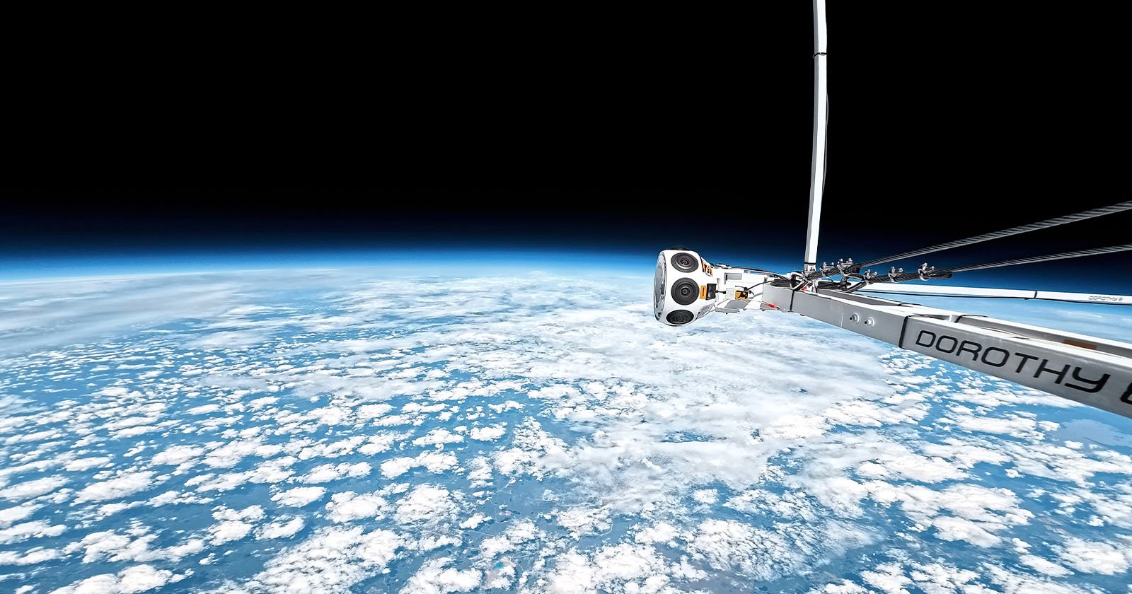A camera attached to a metallic arm labeled DOROTHY captures a view of Earth from high altitude, showing curved horizon, white clouds, and the blackness of space above.
