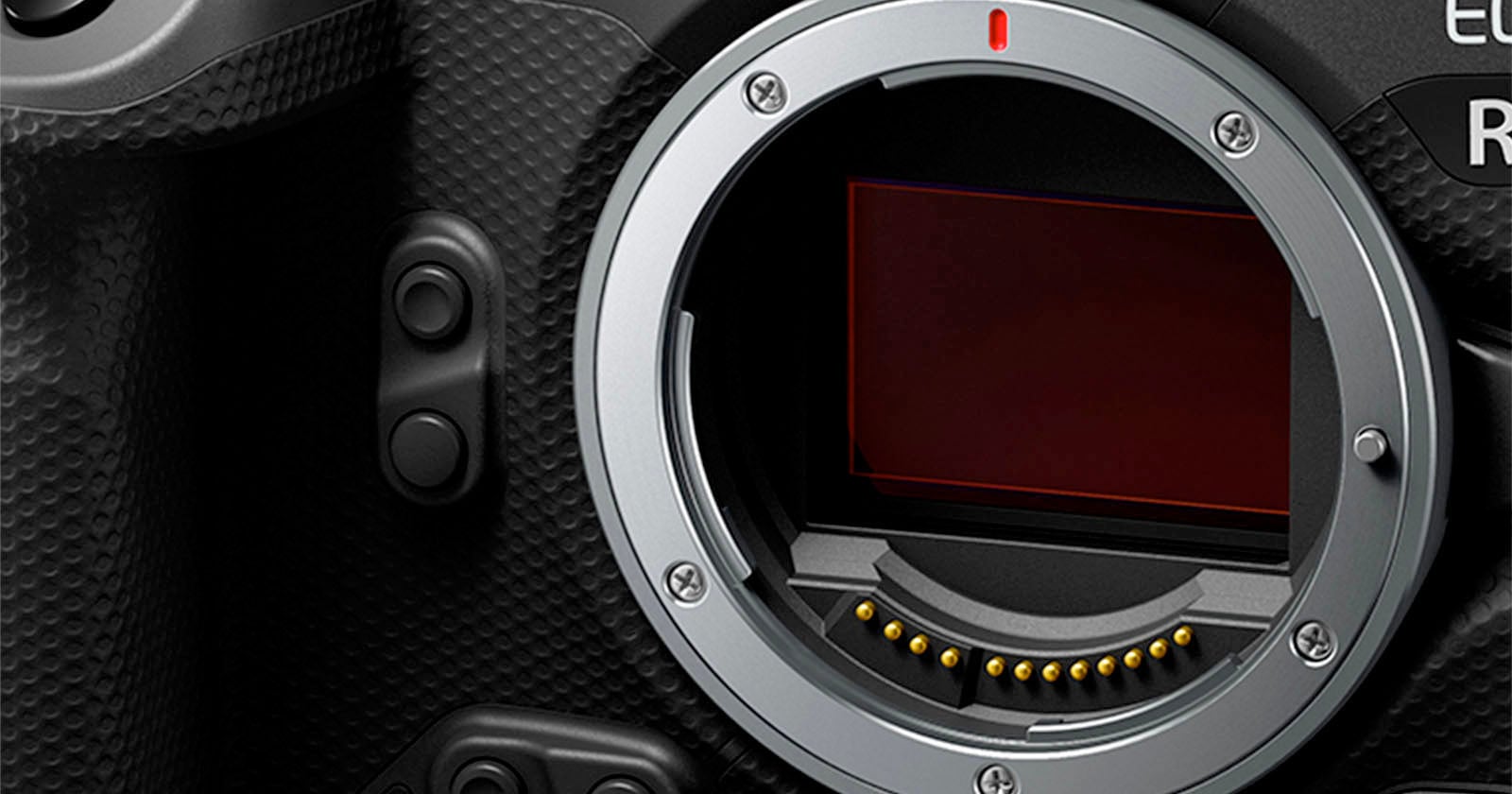 Close-up of a digital camera body showing the lens mount and exposed image sensor, with textured grip and control buttons visible on the left side.