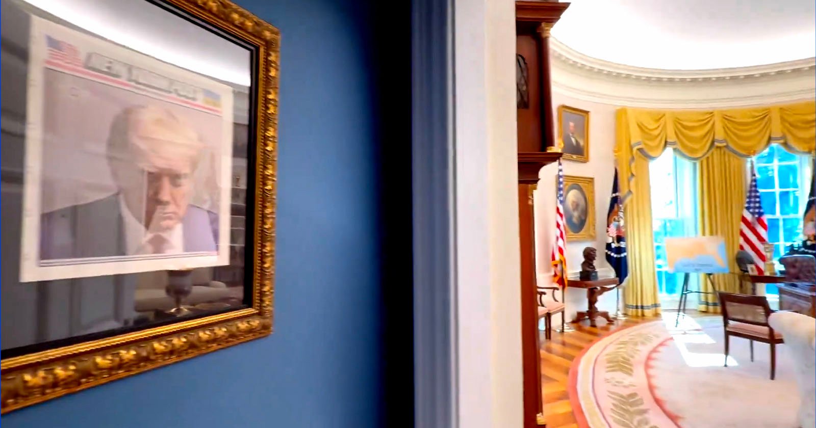 A gold-framed photo of a person in a suit hangs on a blue wall. The frame is near the entrance to an elegant room with yellow curtains, wood furniture, and American flags. The room has a distinctive oval shape with a patterned carpet.