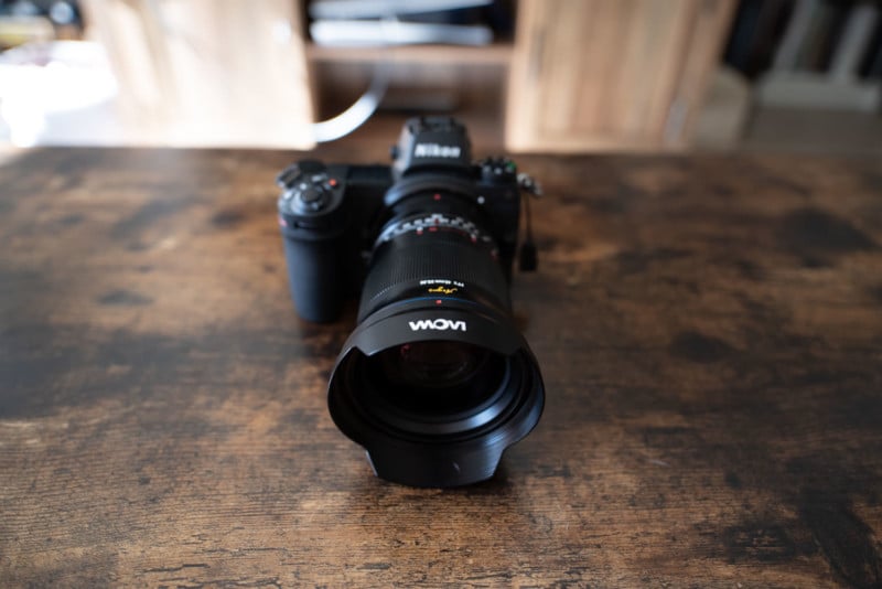 The Laowa Argus 45mm f/0.95 FF mounted on a camera and sitting on a table