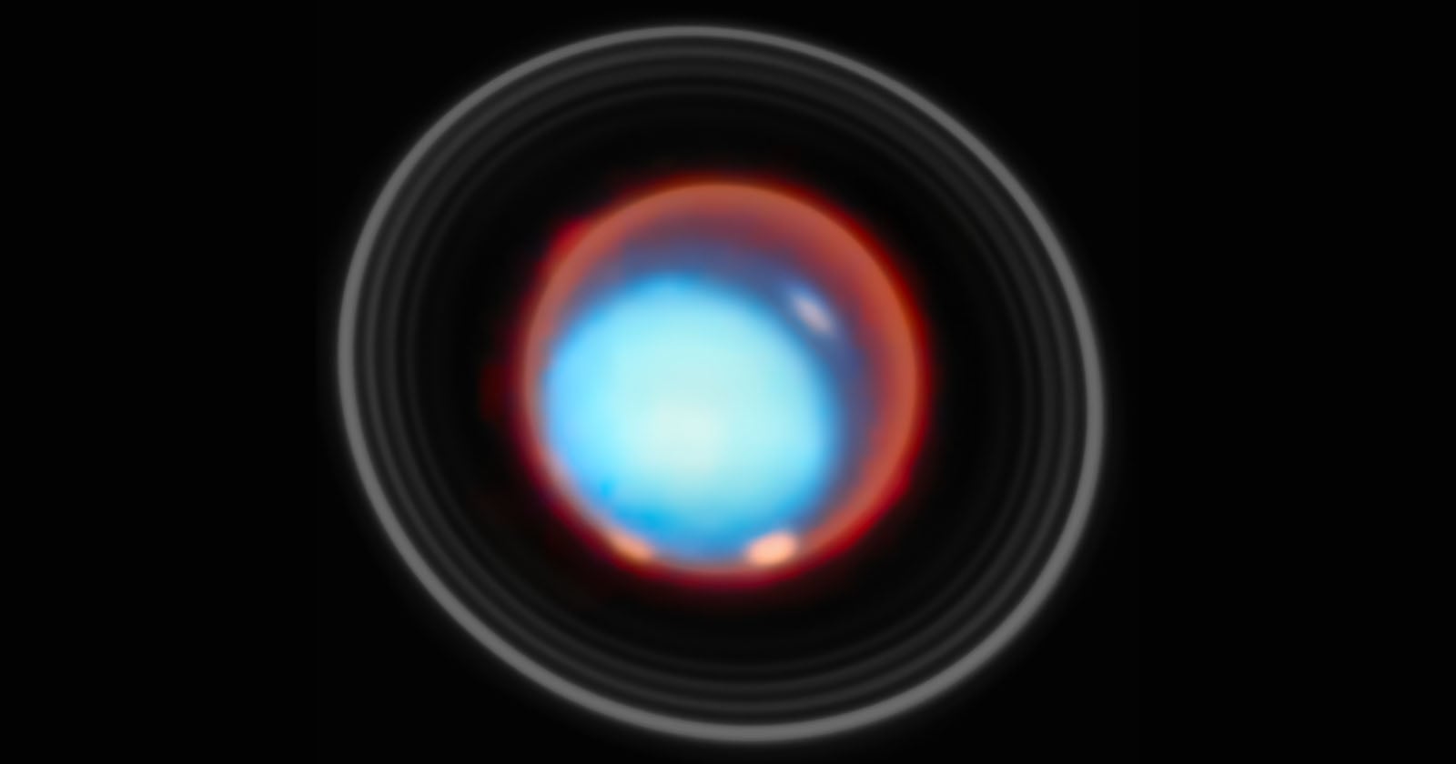 A bright, glowing blue and red circular object with a glowing center, surrounded by faint concentric rings, set against a black background. The image resembles an abstract or cosmic scene.