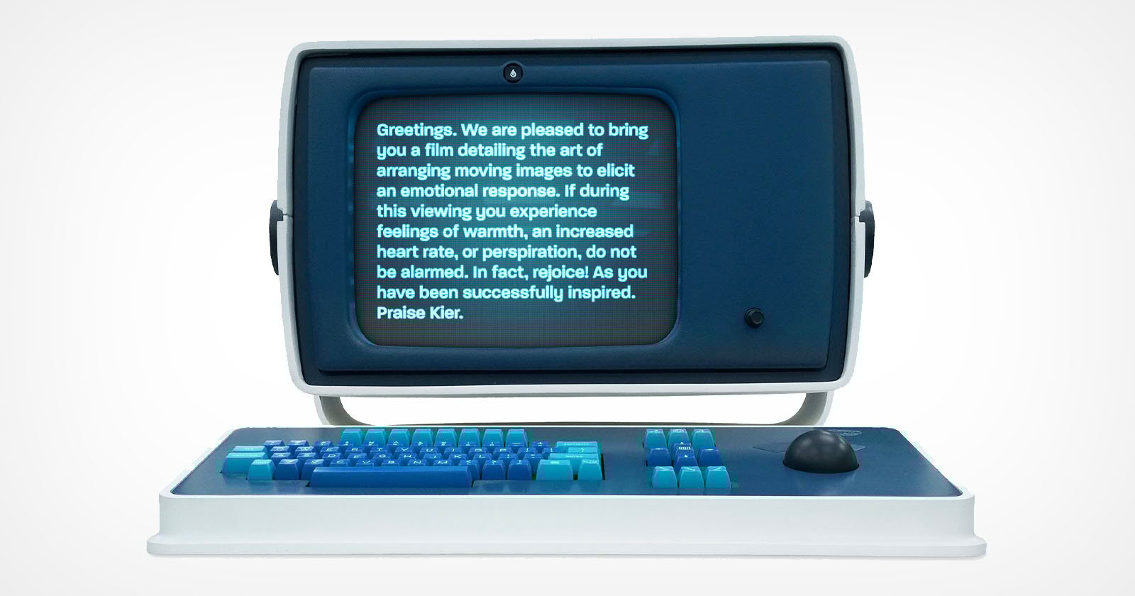 A retro-style computer with a blue screen displays text about film-induced emotional responses. The computer features a blue and teal keyboard and a joystick, evoking a vintage aesthetic.