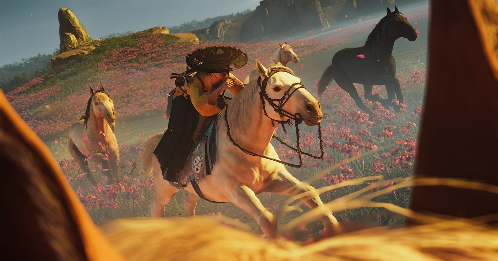 A warrior in traditional Japanese attire rides a white horse through a vibrant field of pink flowers, surrounded by other galloping horses under a bright sky.