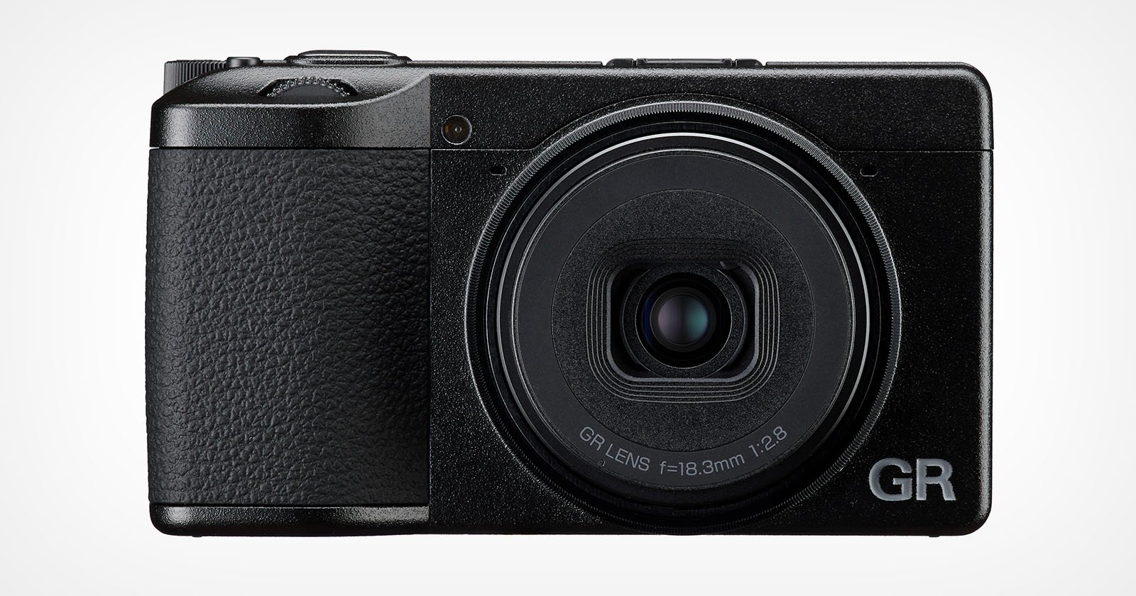 A compact black digital camera with a textured grip, prominent fixed lens, and the letters GR in silver on the bottom right corner of the front panel.