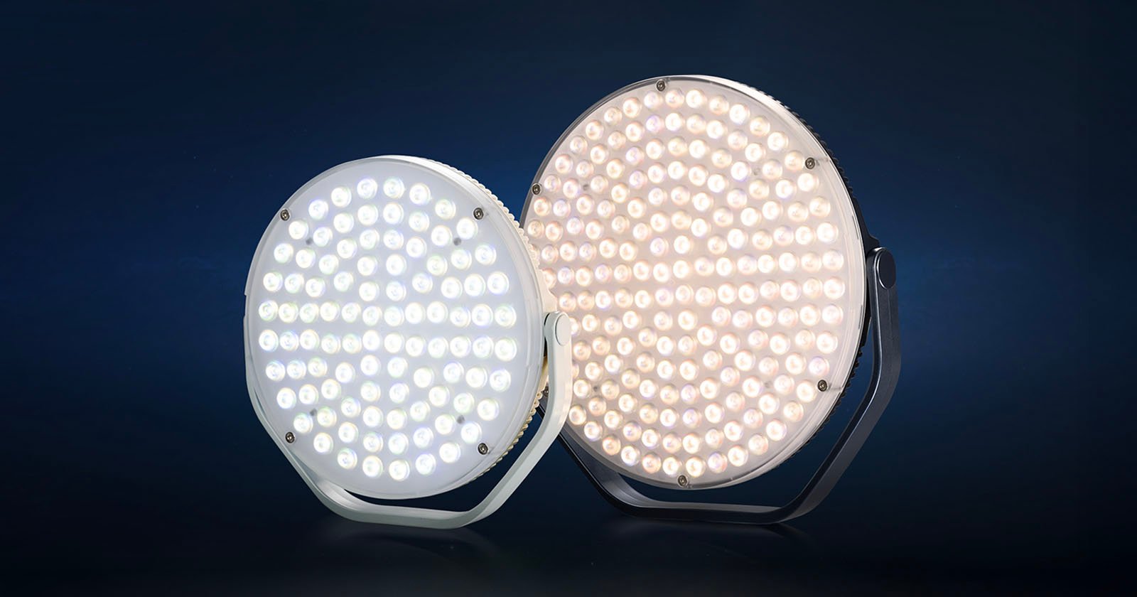 Two round LED stage lights are shown side by side against a dark background. One emits a cool white light, while the other emits a warm white light. Both lights have multiple small LED bulbs arranged in a circular pattern.