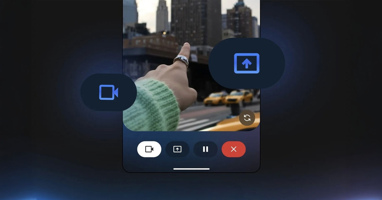 A person’s hand points toward city buildings as seen through a smartphone screen interface, with video and upload icons overlayed and yellow taxis visible in the background.
