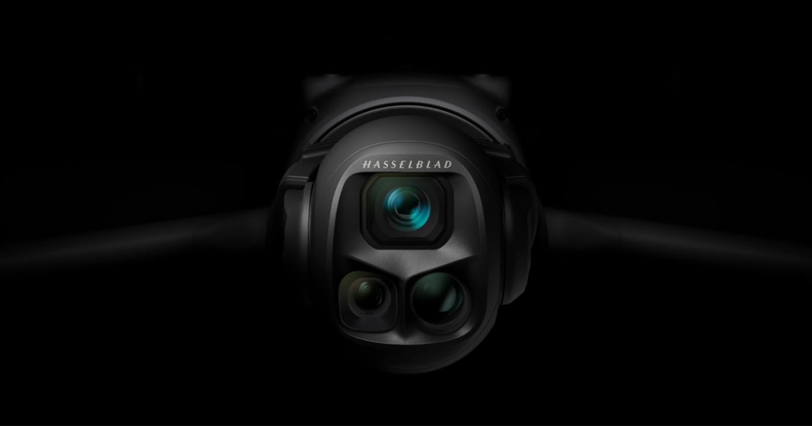 Close-up of a Hasselblad camera with three lenses, set against a dark background, highlighting the camera's sleek and modern design.
