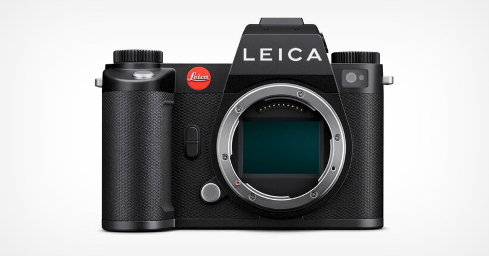 A black Leica mirrorless digital camera without a lens attached is shown. The brand name LEICA is prominently displayed at the top, and the camera's sensor is visible in the central mount area. The camera has a textured grip on the left side.