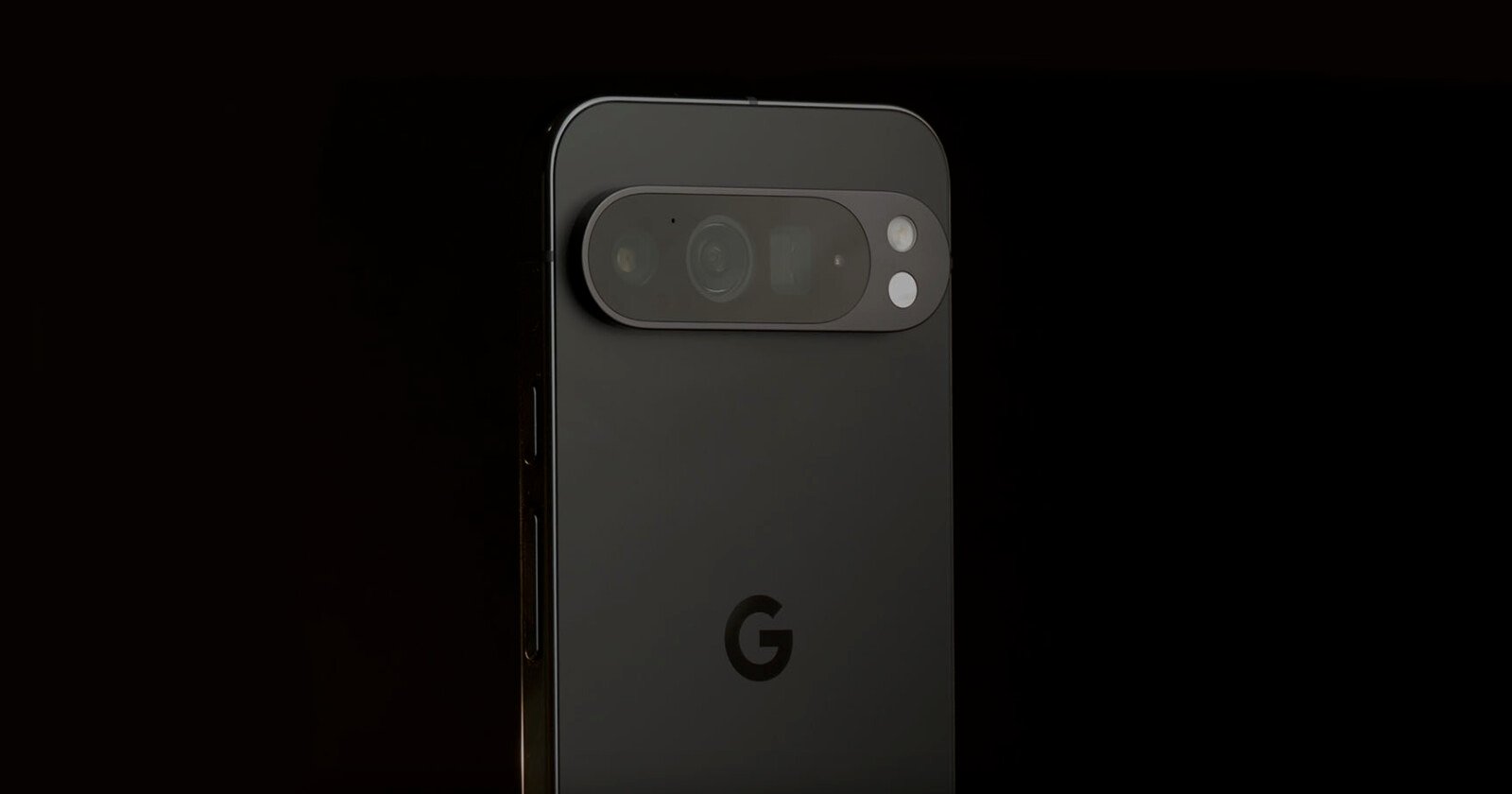 A close-up of the back of a black Google Pixel phone against a dark background, showing the camera bar with multiple lenses and the Google G logo below.