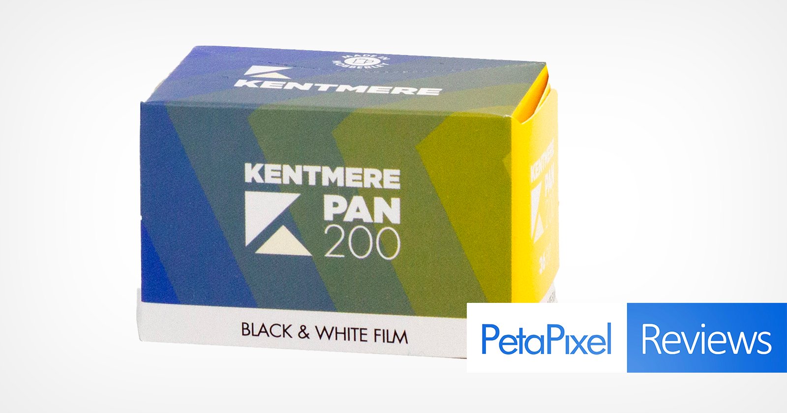 A box of Kentmere Pan 200 black & white film with green, blue, and yellow packaging. The box is angled, showing the film name and logo. Petapixel Reviews is overlaid in the bottom right corner.