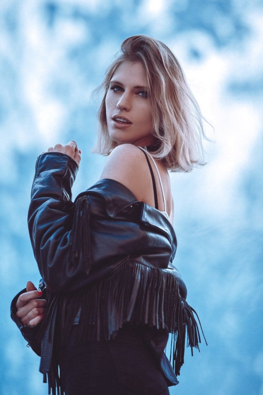 A woman posing against a do-it-yourself dappled light backdrop