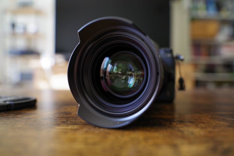 The Laowa Argus 45mm f/0.95 FF mounted on a camera and sitting on a table