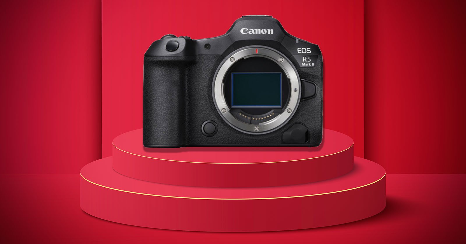 A Canon EOS R5 Mark II mirrorless camera body is displayed on a red, three-tiered circular podium with a matching red background.