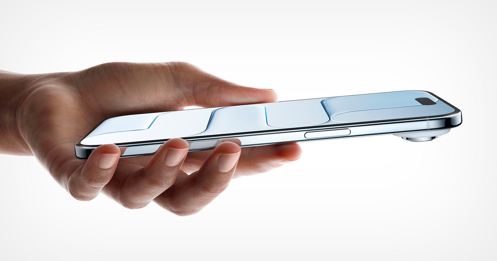 A hand holds a sleek, modern smartphone horizontally, displaying a metallic design with raised, contoured sections and a camera bump on the top right edge against a plain white background.