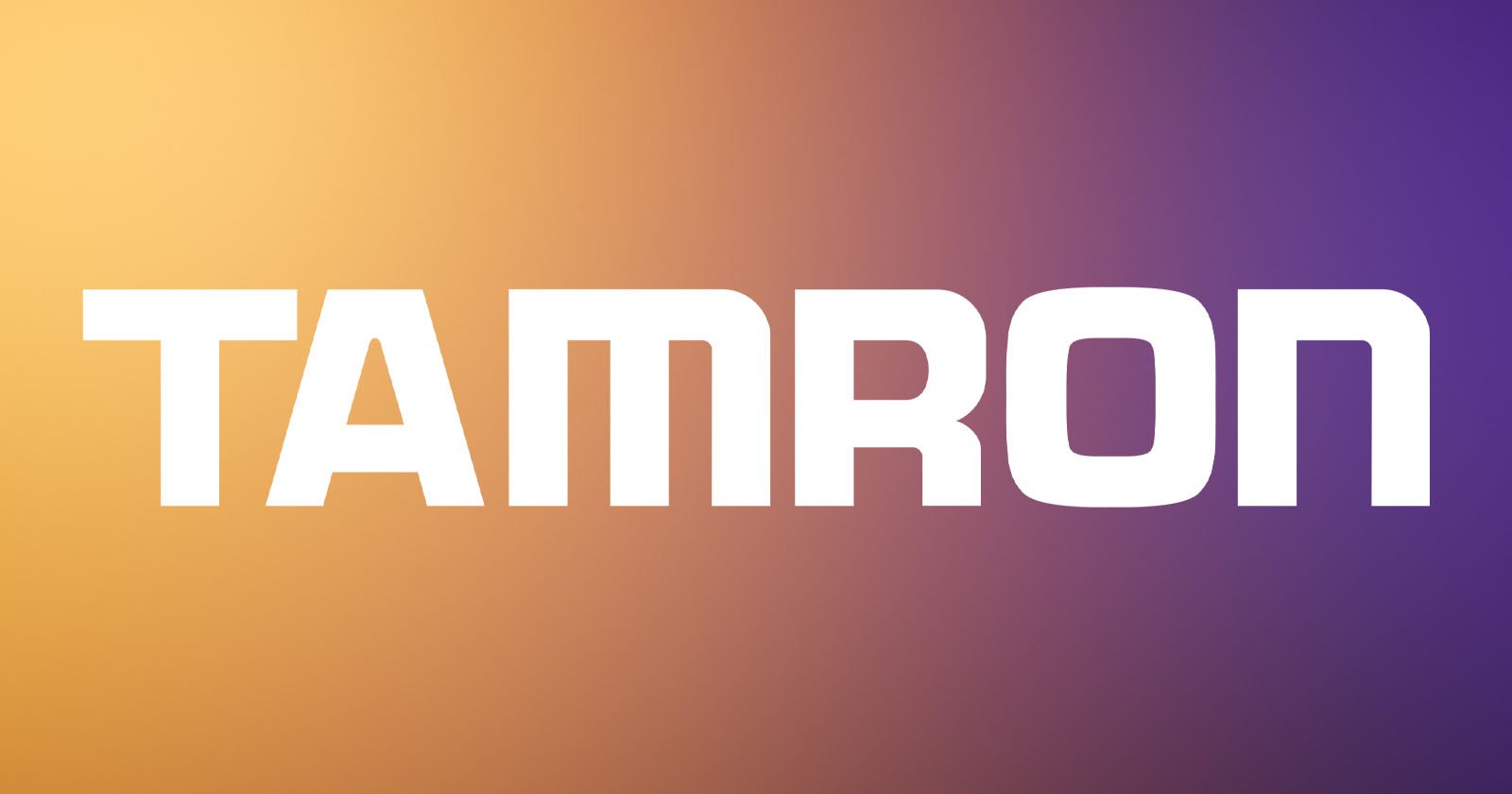 The image features the word TAMRON in bold, white uppercase letters centered on a gradient background that transitions from orange on the left to purple on the right.