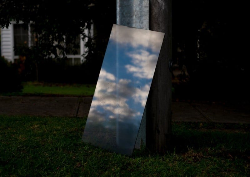 A photo of a pane of glass leaning in front of a house 