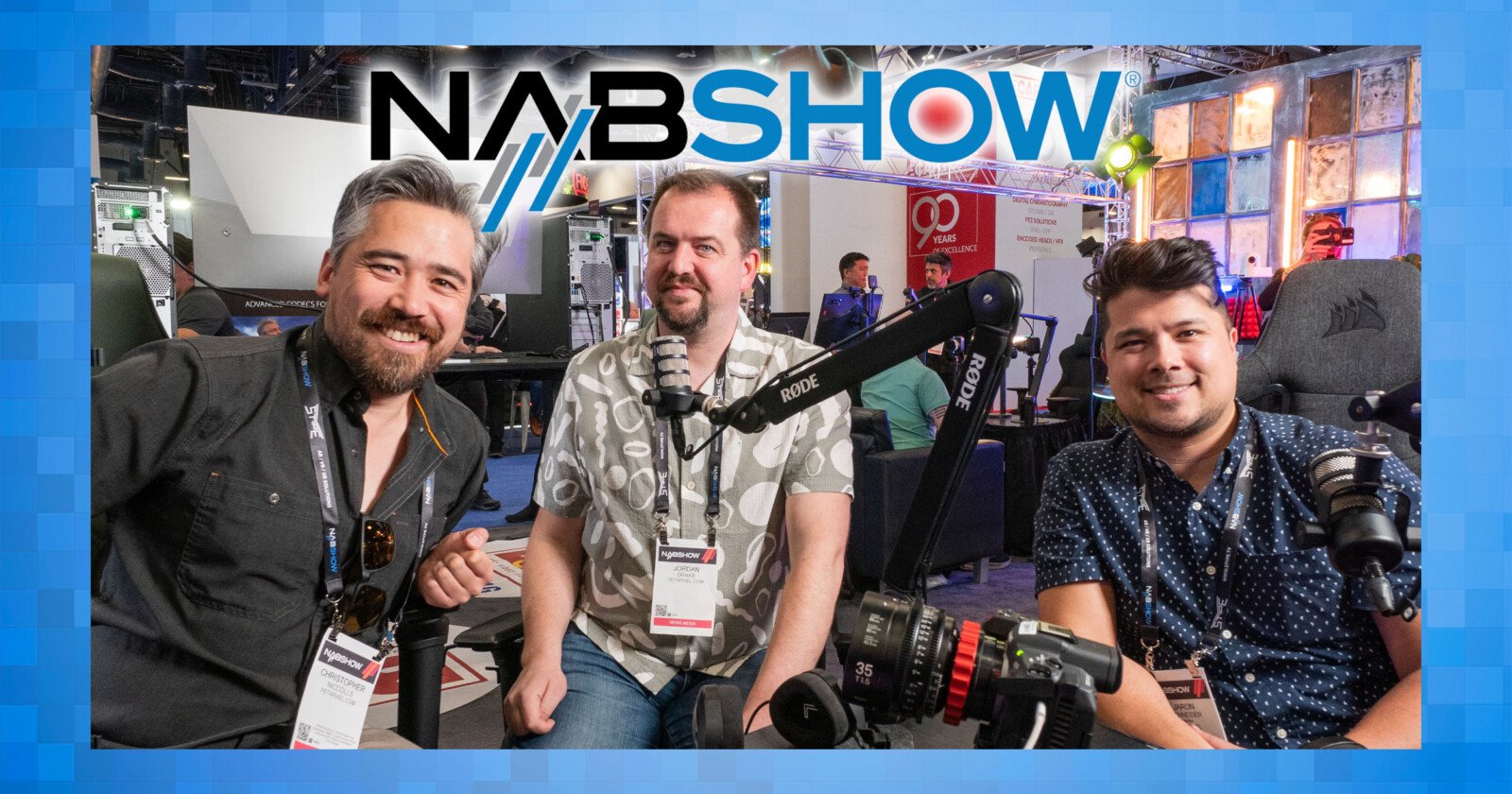 Three people are sitting and smiling at the NAB Show, surrounded by audio equipment, including microphones. The event logo is prominently displayed at the top. The background features a lively exhibition setting.