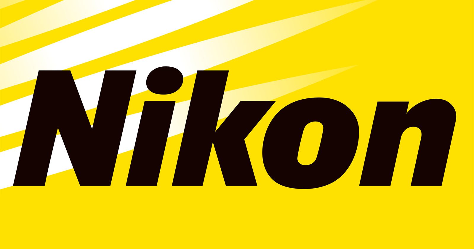 The image displays the Nikon logo, which consists of the word Nikon in bold black letters on a yellow background with three white diagonal stripes at the top left corner.