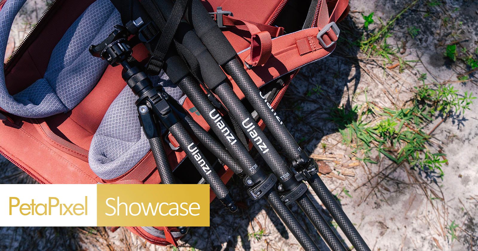 A close-up view of a red backpack and three collapsed tripod legs branded udrizi lying on the ground, viewed from above, indicating preparation for a photography excursion.