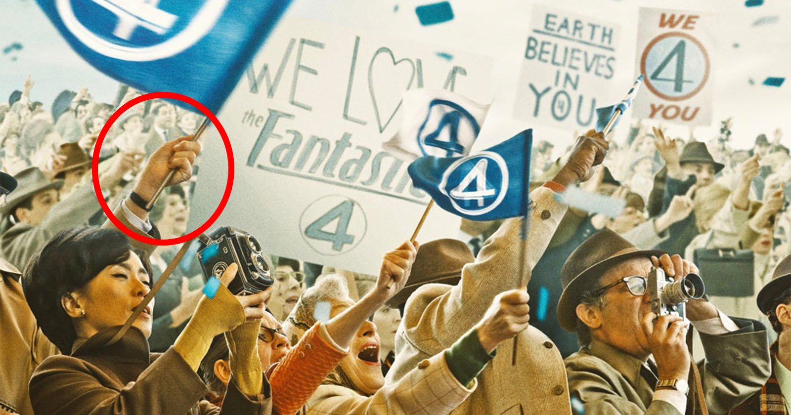 A crowd excitedly waves blue flags with the number 4, holding cameras and signs. One sign reads, WE LOVE the Fantastic 4, while another says, EARTH BELIEVES IN YOU. A circled hand in the foreground gestures with two fingers raised.