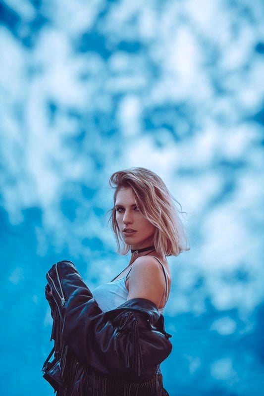 A woman posing against a do-it-yourself dappled light backdrop