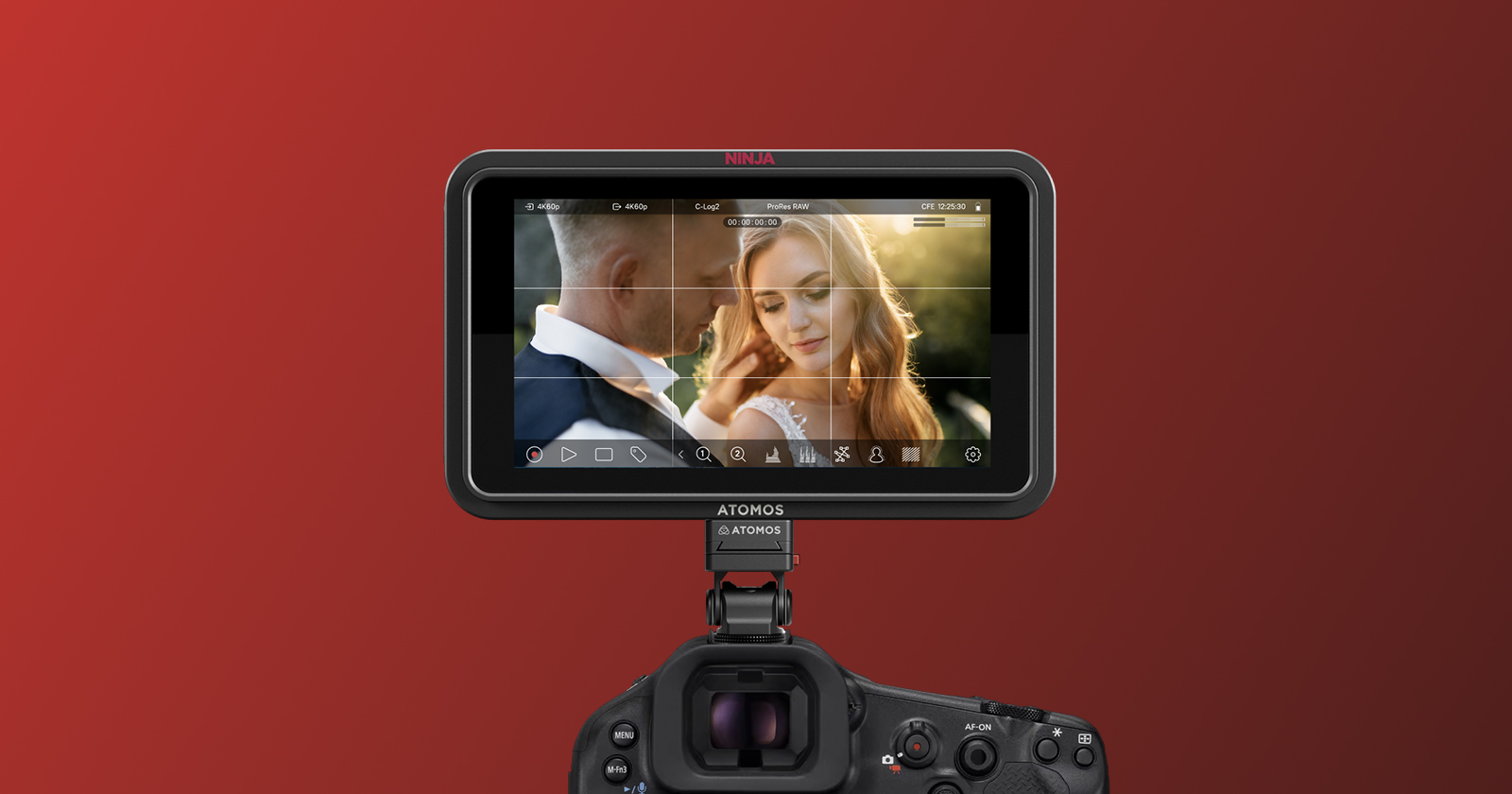 A camera monitor displays a close-up of a man and a woman, with the woman smiling and touching her hair, against a blurred background and a red gradient backdrop.