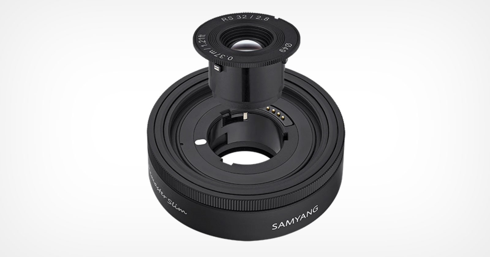 A black Samyang camera lens with an additional smaller lens attachment placed on top, showing the interior components and electronic contacts. The main lens is marked SAMYANG and the smaller attachment is marked 8.2/2.8. The design appears sleek and modern.