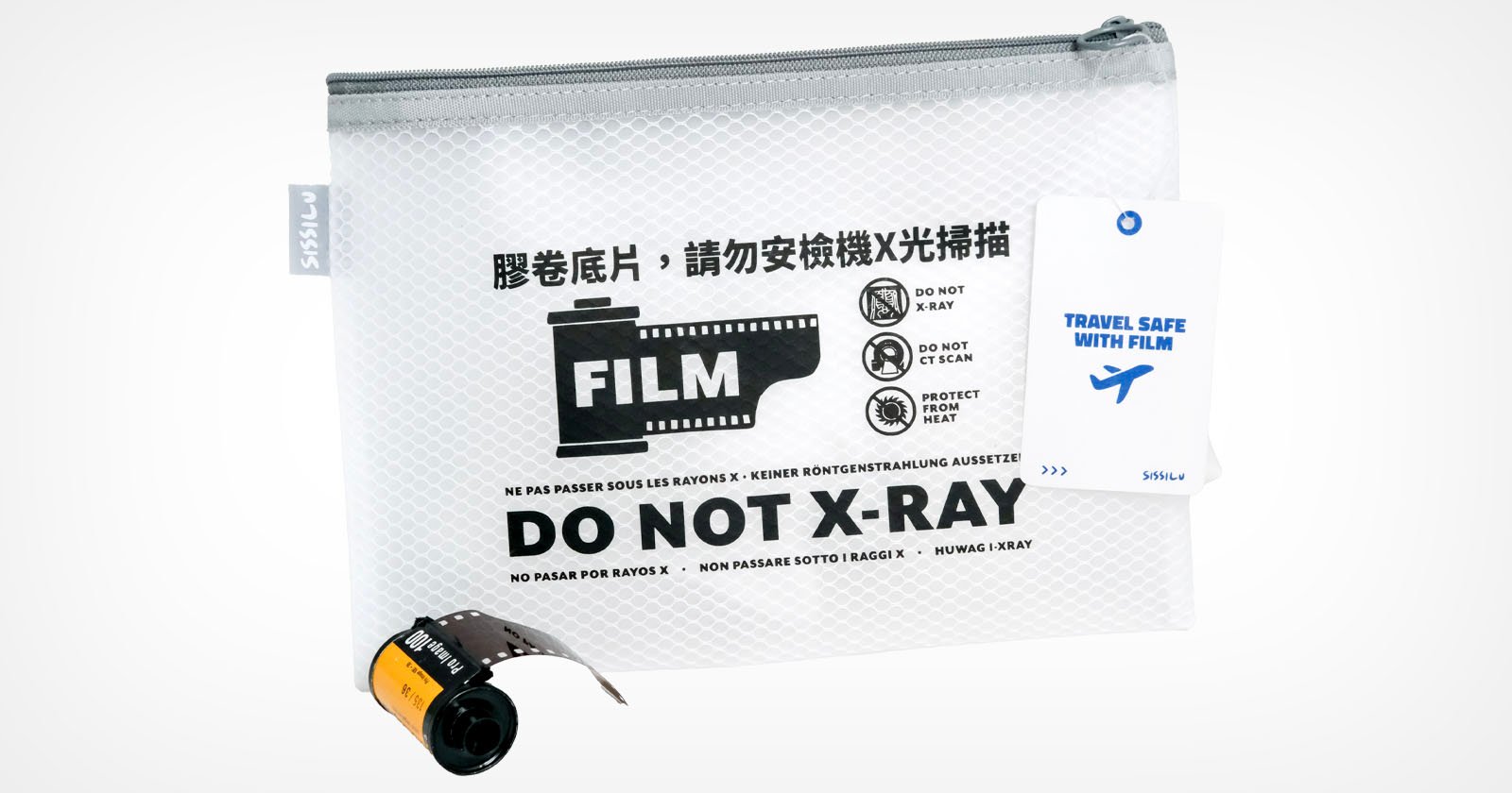 A mesh zipper pouch labeled FILM DO NOT X-RAY in English and other languages, with a graphic of a film roll and airport security icons, a travel tag, and a film canister placed in front of the pouch.