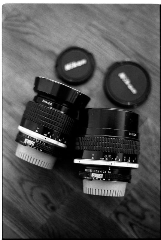 Two vintage Nikon lenses on a table