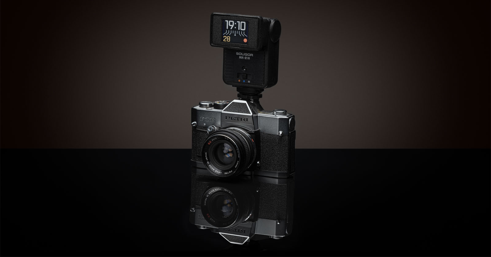 The DIY digital clock within a flash unit mounted on a camera.